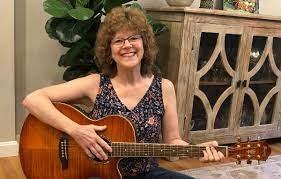 Deb Hudgins holding a guitar