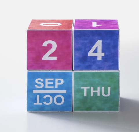 calendar made from 4 wooden blocks in a variety of colors