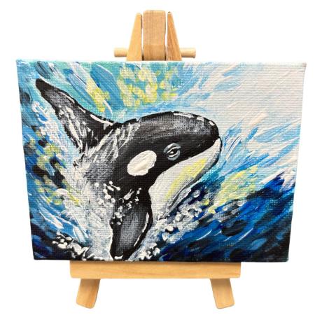 tiny canvas of an orca whale in the ocean