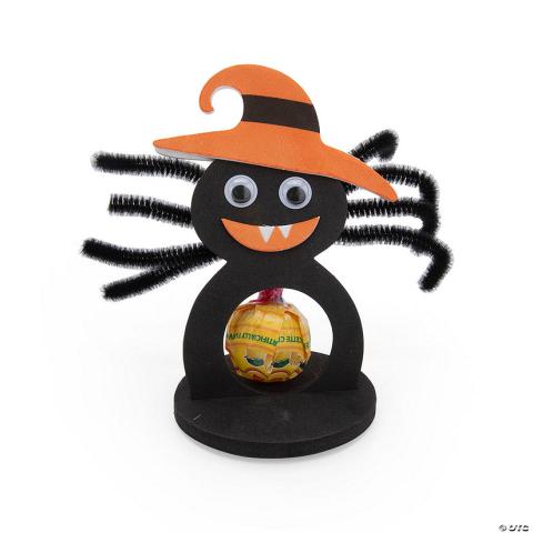 foam craft of a spider wearing an orange witch's hat and a lollipop center