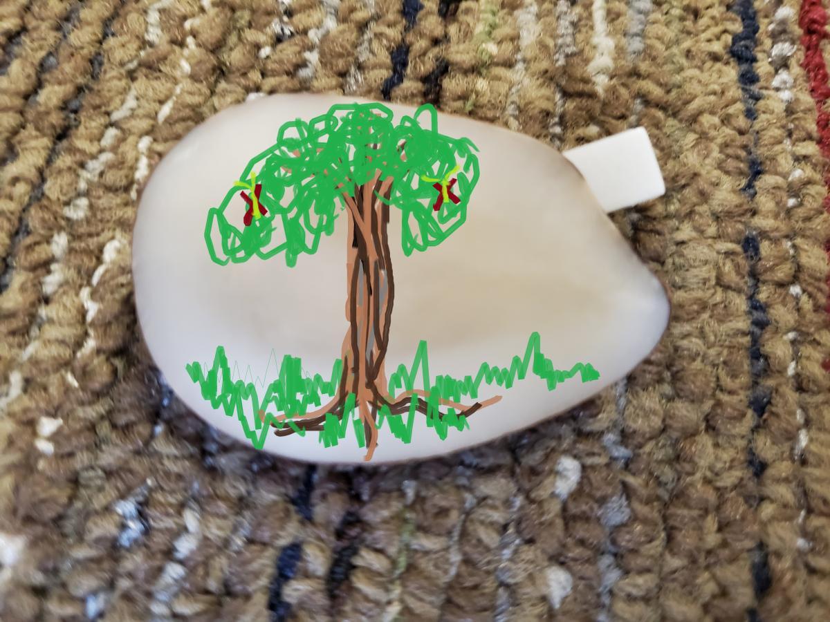 Tagua Nut Pin with a painting of a tree on it