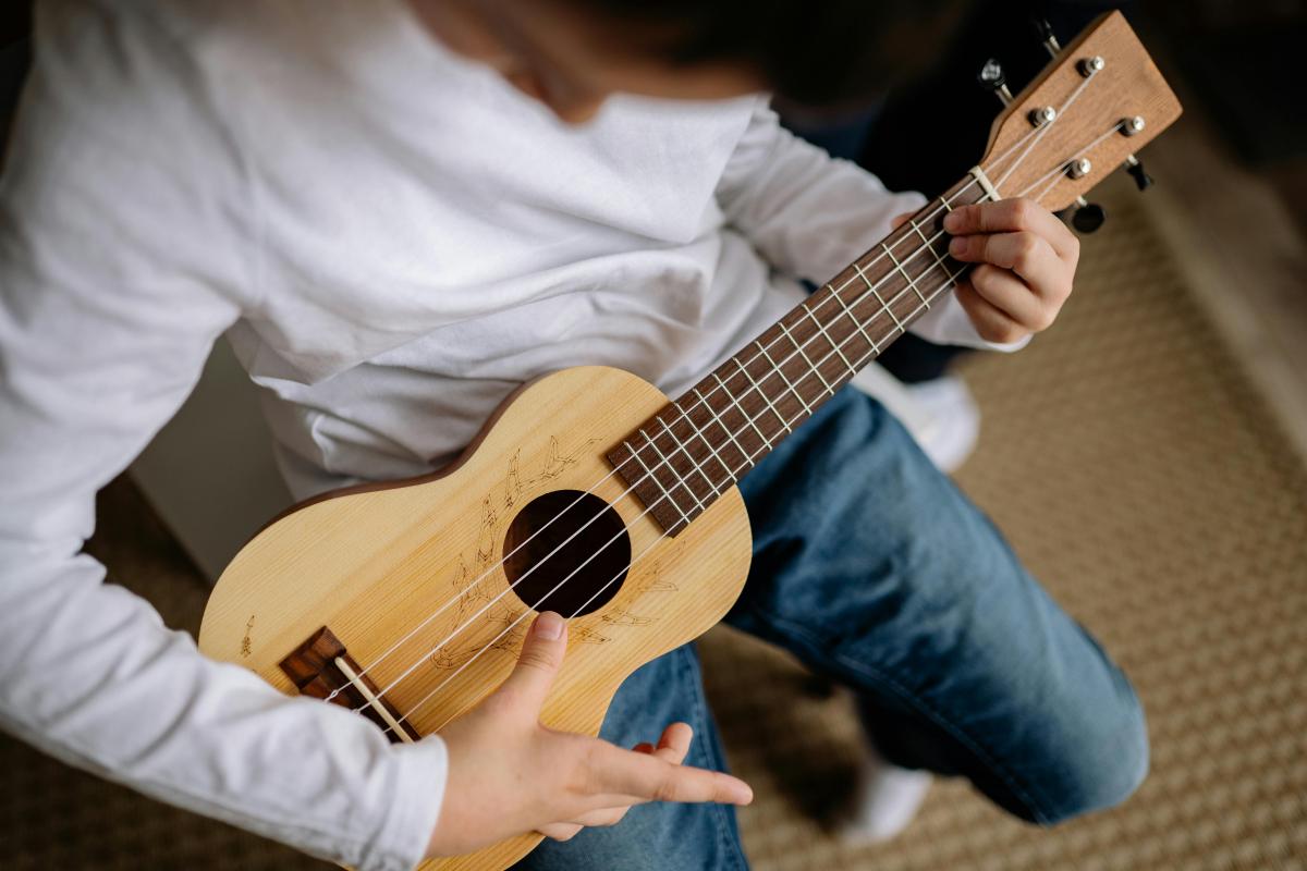 young man playing the ukulele